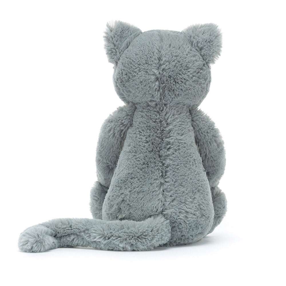 Jellycat Bashful Kitten Original plush toy in soft beige with blue eyes, lying on a white background.