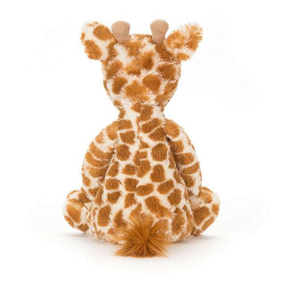 Medium Bashful Giraffe plush toy by Jellycat with soft fur and floppy limbs, perfect for cuddling and playtime.
