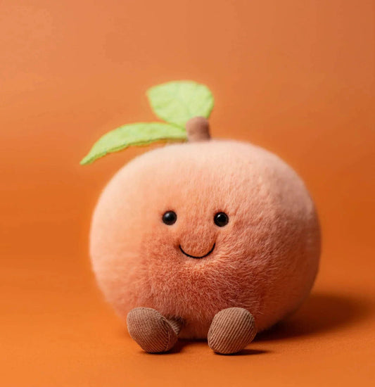 Jellycat Amuseables Peach plush toy with soft, fuzzy texture and cheerful facial expression, perfect for cuddling and play.